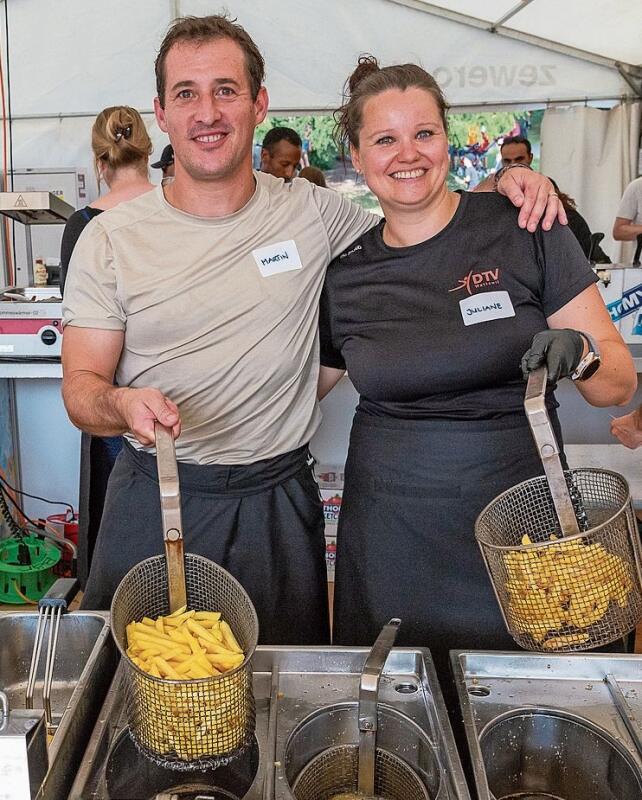 Gut gelaunt an der Fritteuse: Die freiwilligen Helfer Martin und Juliane.